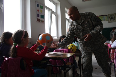 Soldiers bring gifts and teach dental hygiene to students