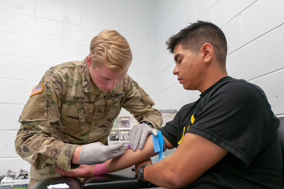 Pfc. Baker draws blood during the physical health assessment