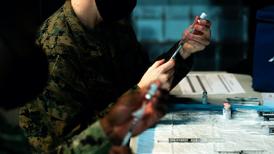 Deploying Marines and Sailors receive COVID-19 Vaccination